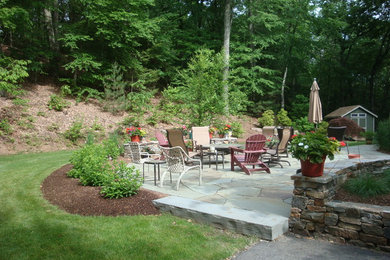 Patio - mid-sized traditional backyard stone patio idea in Bridgeport with a fire pit and no cover