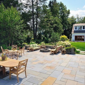 Bluestone patio with seat wall, fire pit and patio furniture
