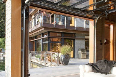 Inspiration for a contemporary patio remodel in Seattle with a roof extension