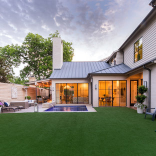 Large contemporary backyard patio in Dallas with a fire feature, decking and an awning.