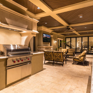This is an example of an expansive mediterranean courtyard patio in Phoenix with a fire feature, concrete pavers and no cover.