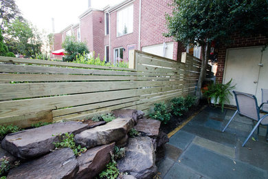 Inspiration for a small contemporary backyard stone patio remodel in Baltimore with no cover