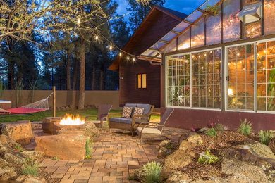 Patio - large rustic backyard brick patio idea in Phoenix with a fire pit and no cover
