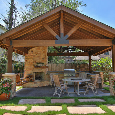 Large mountain style backyard concrete patio kitchen photo in Houston with a gazebo