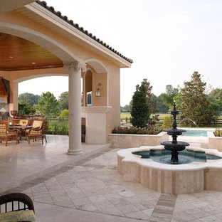Esempio di un patio o portico mediterraneo con fontane