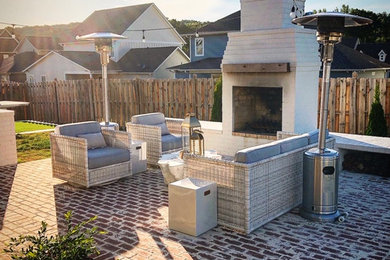 Patio - large shabby-chic style backyard brick patio idea in Birmingham with a fireplace