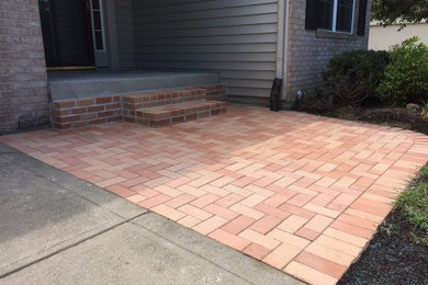 Mid-sized elegant front yard brick patio photo in Indianapolis with no cover