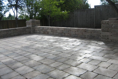 Example of a mid-sized classic backyard brick patio design in Calgary