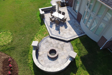 Patio - large backyard brick patio idea in Detroit