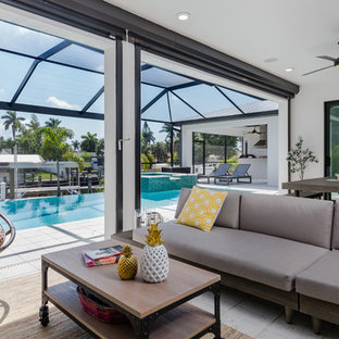 Inspiration for a contemporary backyard patio kitchen remodel in Miami with a roof extension