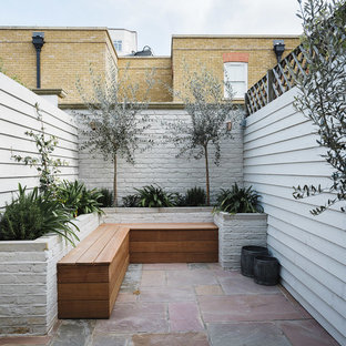 Contemporary back patio in London with no cover.