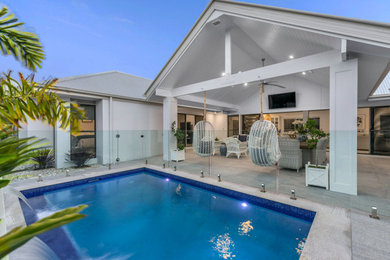 Large beach style side yard concrete patio photo in Brisbane with a roof extension