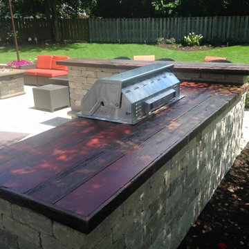 Built in outdoor grill and bar with barn wood counter top