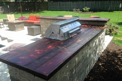 Built in outdoor grill and bar with barn wood counter top
