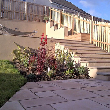 Bull-nosed sawn sandstone steps with rendered walls and risers