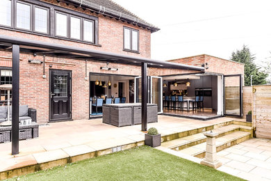 Design ideas for a large contemporary patio in Hertfordshire.