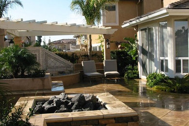 Photo of a medium sized traditional back patio in Los Angeles with a fire feature and a pergola.
