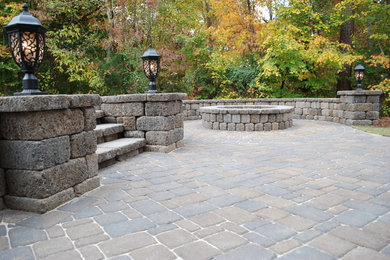 Inspiration for a mid-sized timeless backyard concrete paver patio remodel in Charlotte with a fire pit and no cover