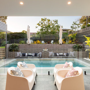 Photo of a contemporary backyard patio in Brisbane with a roof extension.