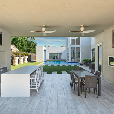 Patio kitchen - large contemporary backyard tile patio kitchen idea in Dallas with a roof extension