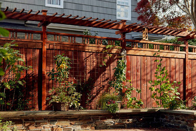 Ejemplo de patio de estilo americano de tamaño medio sin cubierta en patio trasero con brasero y entablado