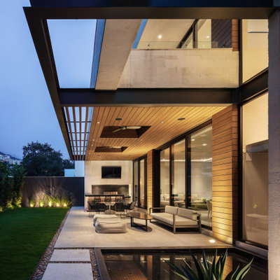 Mid-sized trendy backyard concrete patio kitchen photo in Austin with a roof extension
