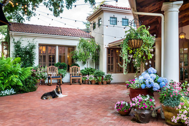 Inspiration for a large mediterranean courtyard brick patio remodel in San Francisco