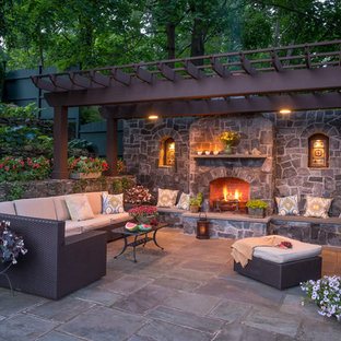 Example of a huge classic patio design in New York with a fire pit and a pergola