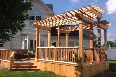 Inspiration for a timeless backyard patio remodel in Chicago with decking and a pergola