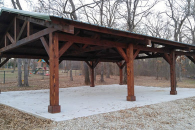 Inspiration for a large rustic backyard concrete patio remodel in Dallas with a gazebo