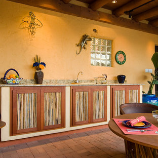 Patio kitchen - mid-sized mediterranean courtyard brick patio kitchen idea in Phoenix with a gazebo