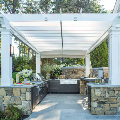 Beach style backyard patio photo in Boston with a pergola