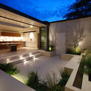 Contemporary courtyard patio in London with concrete slab and no cover.