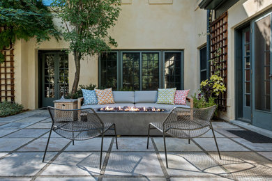 Inspiration for a mid-sized mediterranean backyard stone patio remodel in Denver with a fire pit