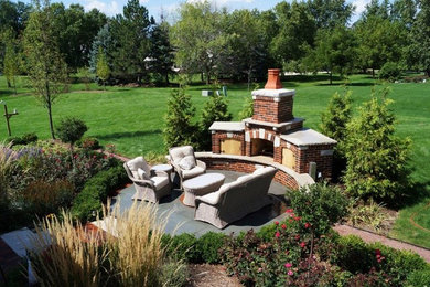 Patio - large traditional backyard brick patio idea in Chicago with a fire pit