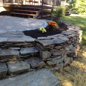 Cicular Patio with Stacked Stone Edging and Deck