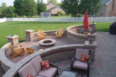 Patio - large traditional backyard concrete paver patio idea in Chicago with a fire pit and no cover