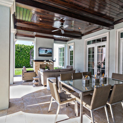Inspiration for a large transitional backyard tile patio remodel in Miami with a fire pit and a roof extension
