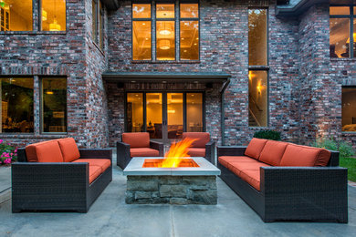 Patio - huge transitional backyard concrete patio idea in Other with a fire pit and no cover