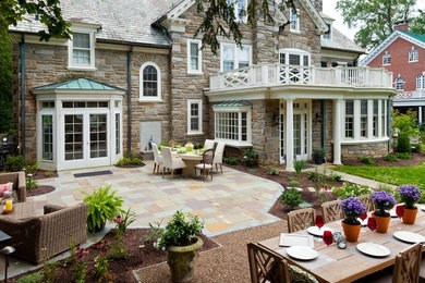 Inspiration for a mid-sized timeless backyard stone patio remodel in Other with a fire pit and no cover
