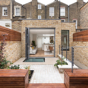 Photo of a medium sized contemporary patio in London with no cover.