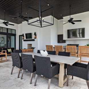 Ispirazione per un grande patio o portico minimal dietro casa con pavimentazioni in cemento e un tetto a sbalzo