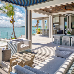 Patio kitchen - coastal backyard tile patio kitchen idea in Tampa with a roof extension