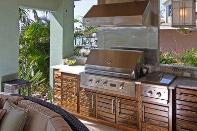Inspiration for a large coastal backyard tile patio kitchen remodel in Tampa with a roof extension