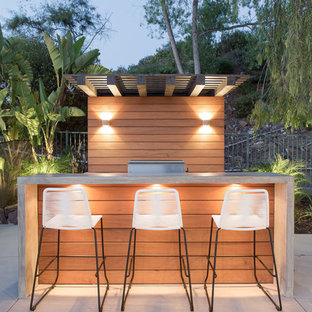 Patio kitchen - contemporary backyard concrete patio kitchen idea in San Diego