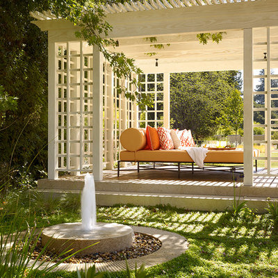 Elegant stone patio photo in Houston with a gazebo