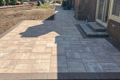 Design ideas for a large traditional back patio in Detroit with concrete paving and no cover.