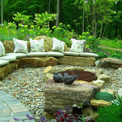 Inspiration for a large timeless backyard gravel patio remodel in Cleveland with a fire pit and no cover