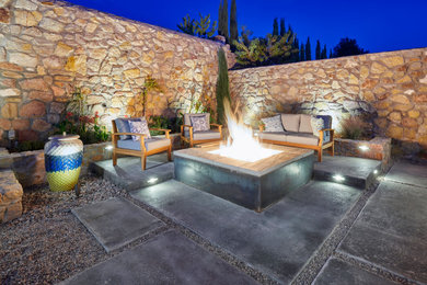 Small trendy backyard concrete patio photo in Other with a fire pit and a pergola