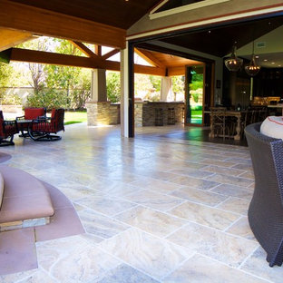 Esempio di un grande patio o portico stile americano dietro casa con piastrelle e un tetto a sbalzo